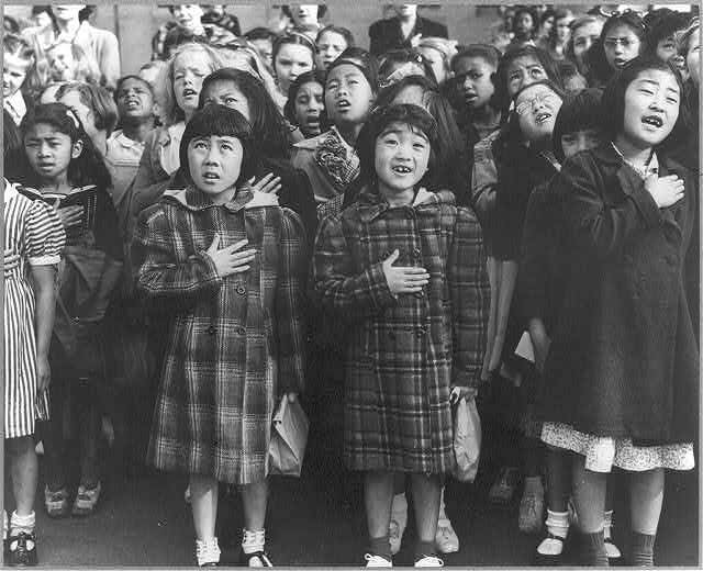 Mary Ann Yahiro recites the Pledge of Allegiance at Raphael Weill School in San Francisco before being sent to Topaz internment camp in Utah, April 1942